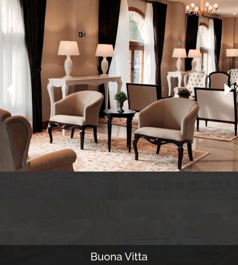 Buona Vitta Gramado Resort & Spa By Gramado Parks מראה חיצוני תמונה The photo shows a stylish and inviting interior space, likely a lounge or waiting area. There are beige upholstered armchairs arranged around a small black table. A decorative plant is placed on the table. Behind the chairs are light-colored walls wi